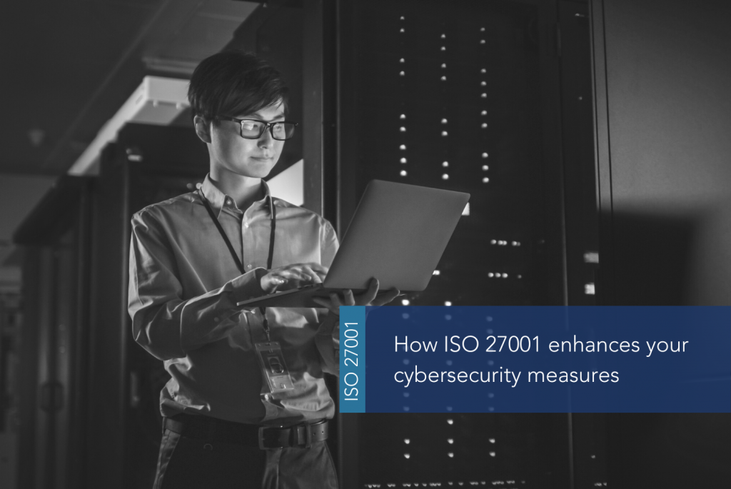 ISO 27001 enhances cybersecurity measures MAIN A person holding a computer